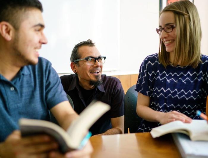 Students in class talking to a professor